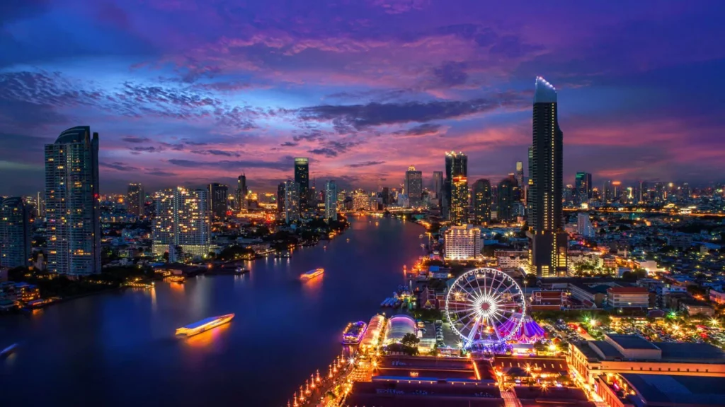 Bangkok's glittering skyline at sunset with illuminated boats cruising along the Chao Phraya River, featuring the iconic Ferris wheel and modern skyscrapers under a dramatic purple sky