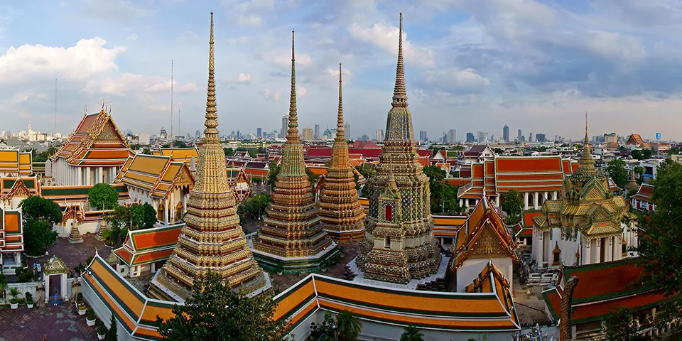 The historic spires and colorful temple buildings of Wat Pho, a fascinating cultural site for families visiting Bangkok