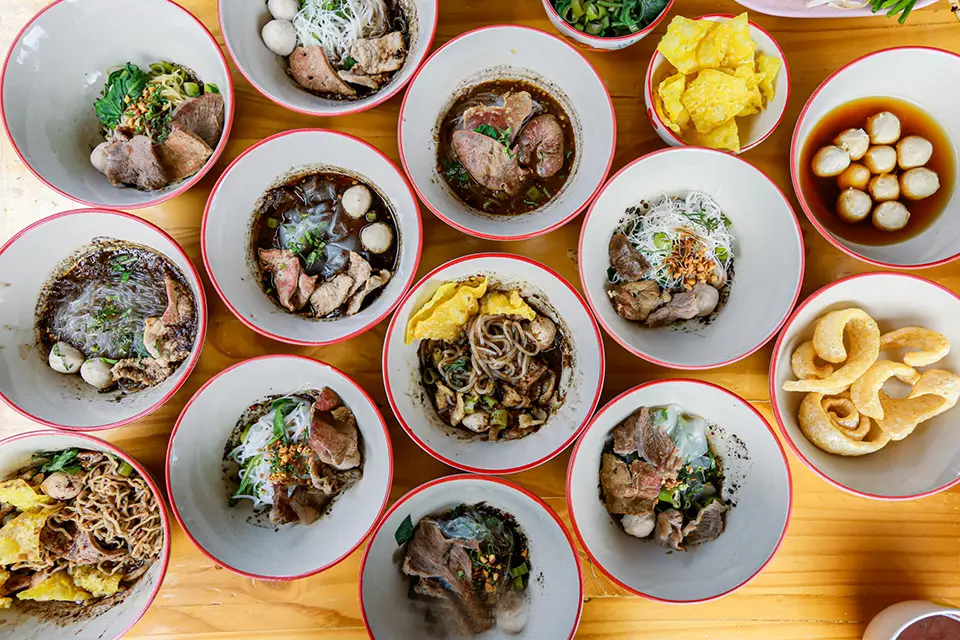 Top Bangkok Street Food: Small bowls of boat noodles with various toppings at Victory Monument, Bangkok's famous street food spot