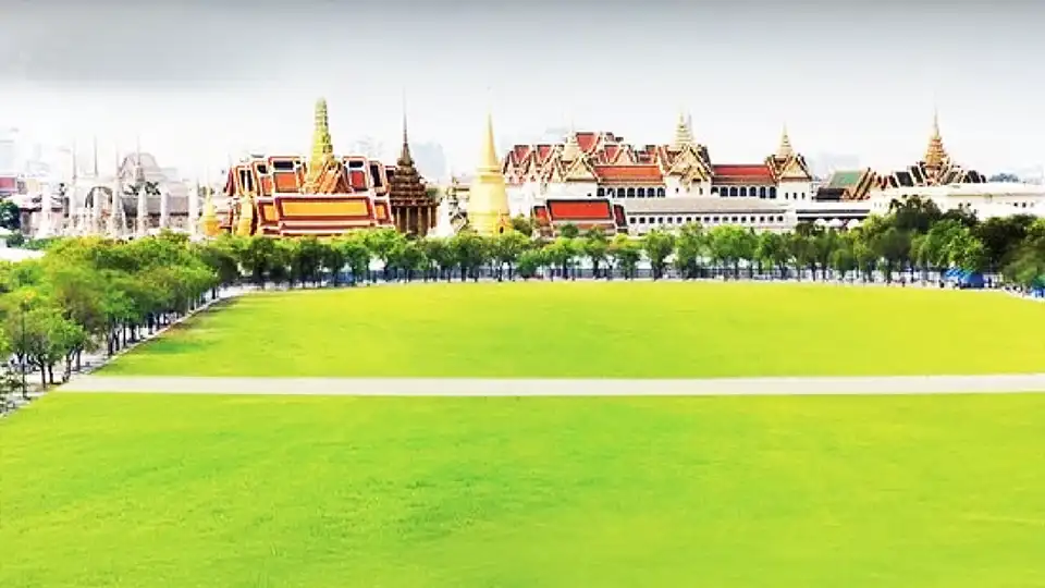 Peaceful stroll across Sanam Luang, framed by iconic Thai architecture and city calm.