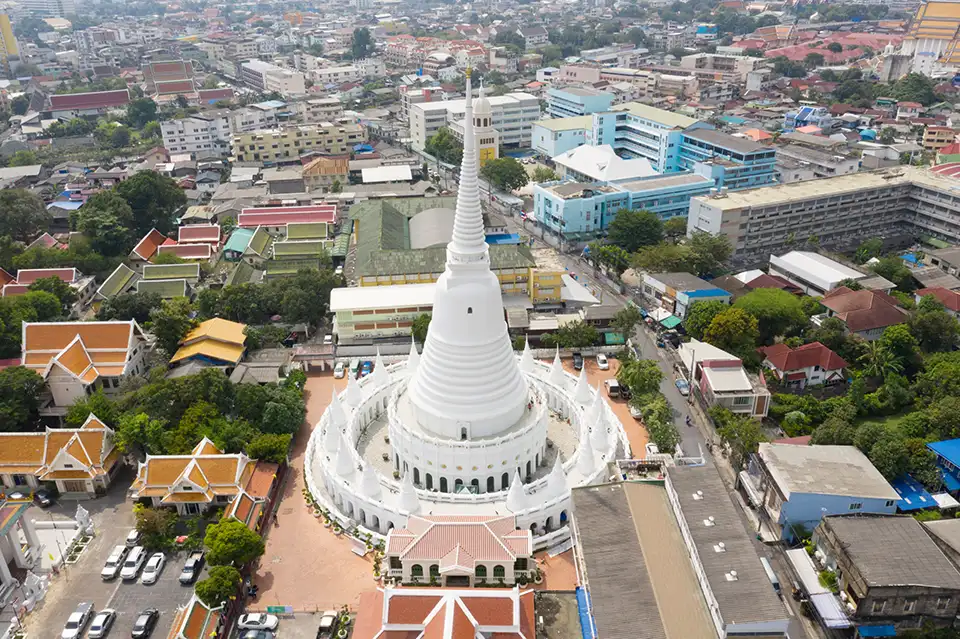 Wat Prayoon's unique white round chedi rising above the surrounding neighborhood in Bangkok"