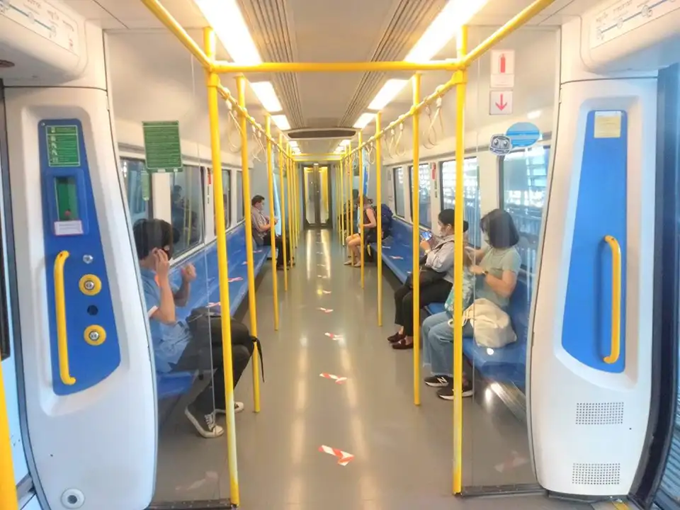 The Airport Rail Link waiting at the platform, showing its comfortable carriages ready to transport travelers between the airport and city