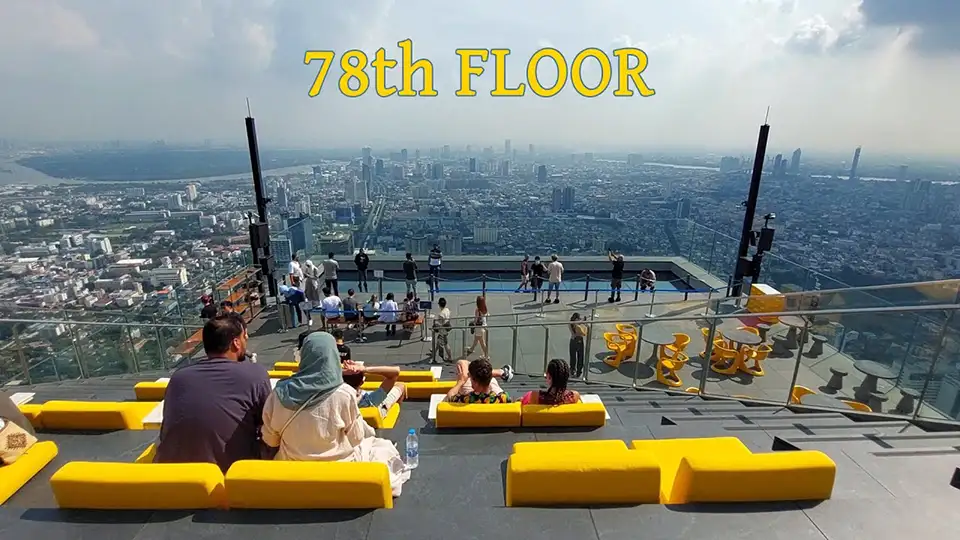High above Bangkok at night, people enjoy the thrill and views from MahaNakhon’s 78th-floor skywalk.