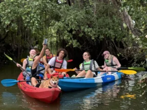 Bangkok Local Tour: Group kayaking through a lush waterway in Bangkok, enjoying nature and adventure.