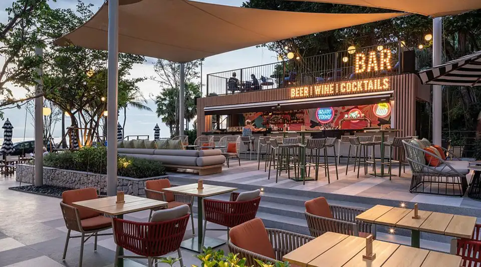 Family Trip in Pattaya: Contemporary beachside dining at The Collective in Pattaya with its sleek bar, shaded terrace seating, and relaxed atmosphere perfect for families