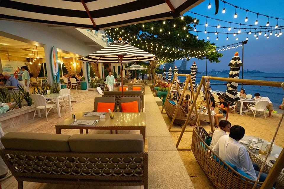 Magical twilight dining experience at Surf & Turf Beach Café Pattaya with twinkling lights and stunning bay views