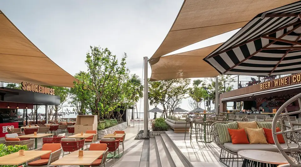 The Collective restaurant terrace at Holiday Inn Pattaya Beach featuring contemporary furniture with fabric canopies and ocean views