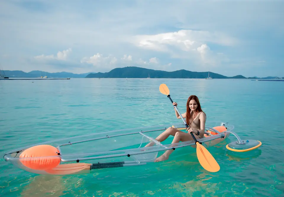 Relaxing kayak experience in clear boat allowing perfect view of the shallow tropical waters below