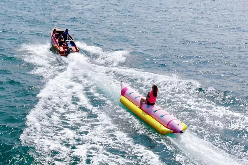 Popular Pattaya water sport featuring high-speed banana boat ride with spectacular water action