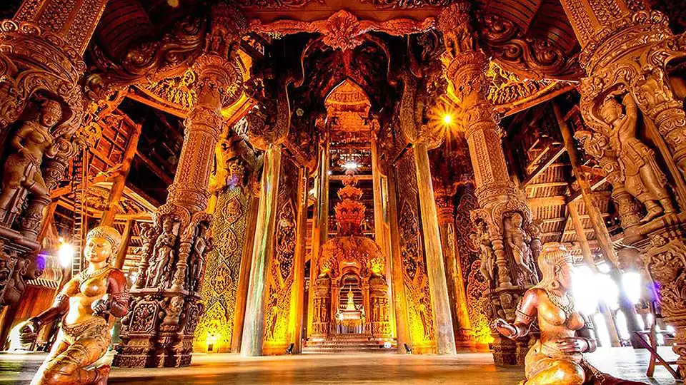Intricate wooden carvings and sculptures inside the Sanctuary of Truth temple in Pattaya, showcasing traditional Thai craftsmanship and architecture