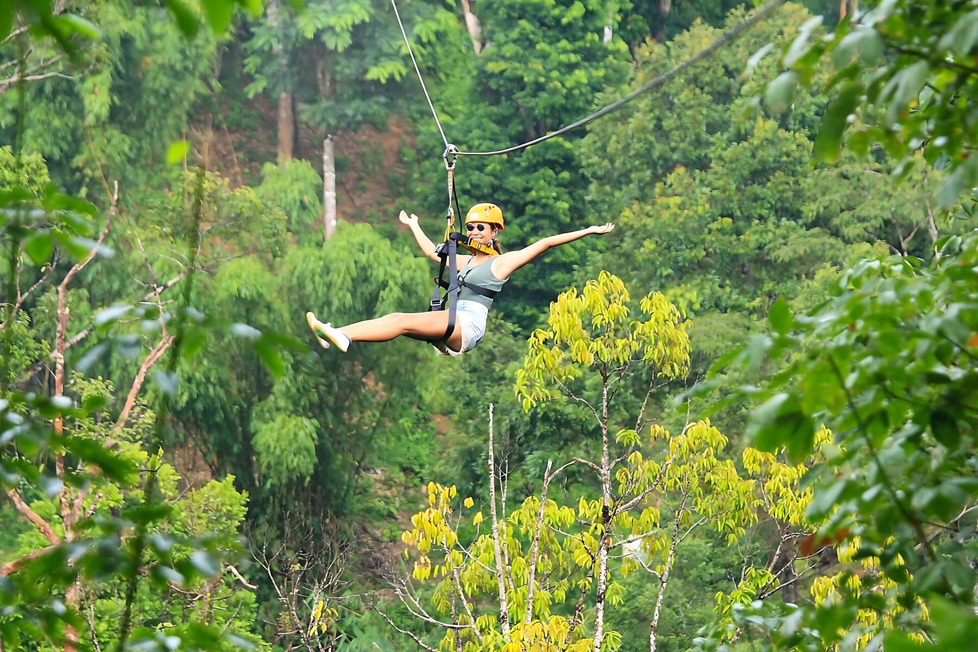 Traveler enjoying a zipline adventure in Phuket's rainforest