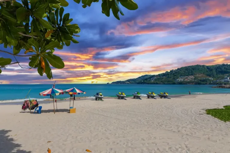 Top Photo Spots in Phuket: Sunset over Phuket beach with jet skis and colorful umbrellas