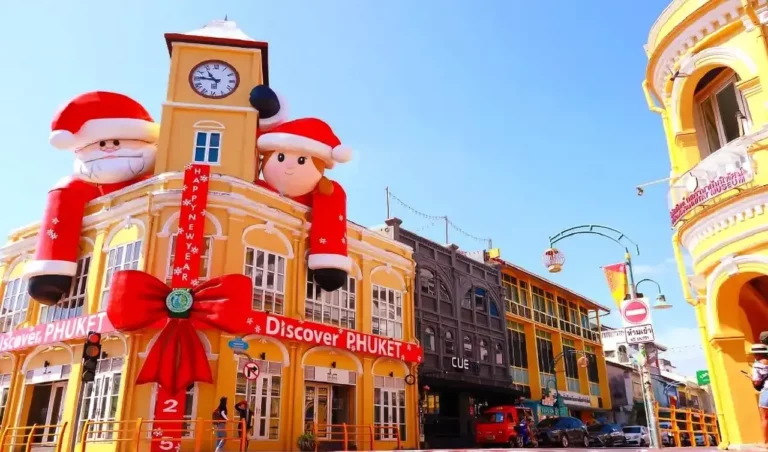 Festive Christmas decorations with oversized Santa displays on historic buildings in Phuket's Old Town