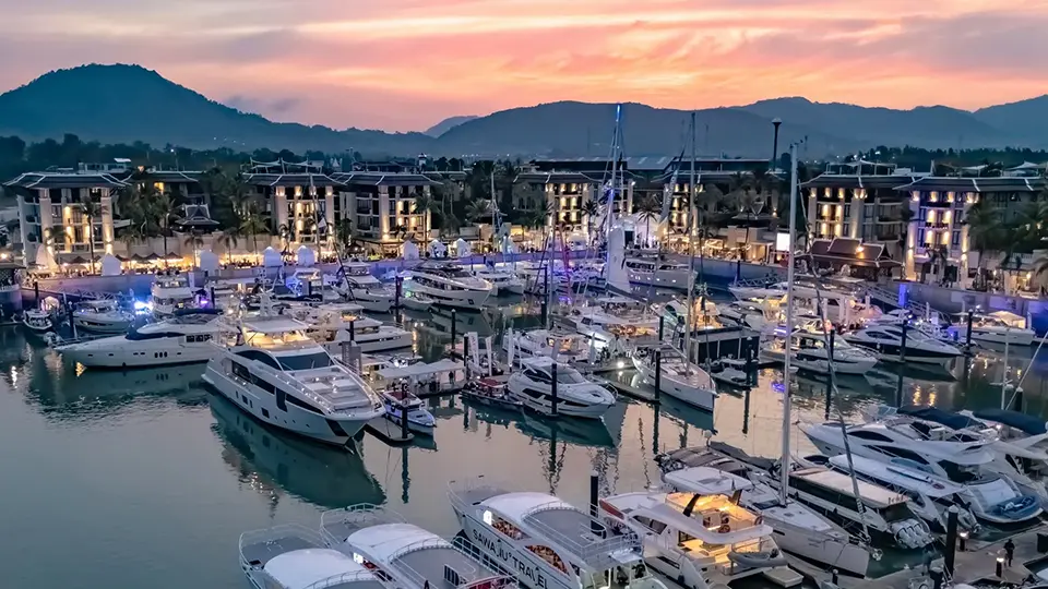 Thailand Luxury Getaway: Evening view of Phuket marina filled with luxury yachts and lined with contemporary waterfront hotels