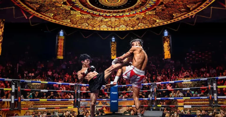 Thai boxing: Two Muay Thai fighters in the ring, one executing a jumping knee strike