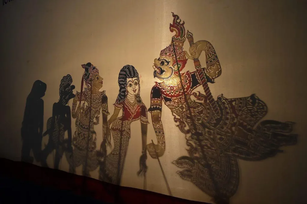 Hidden Thailand: Traditional Thai shadow puppets with intricate designs illuminated on screen