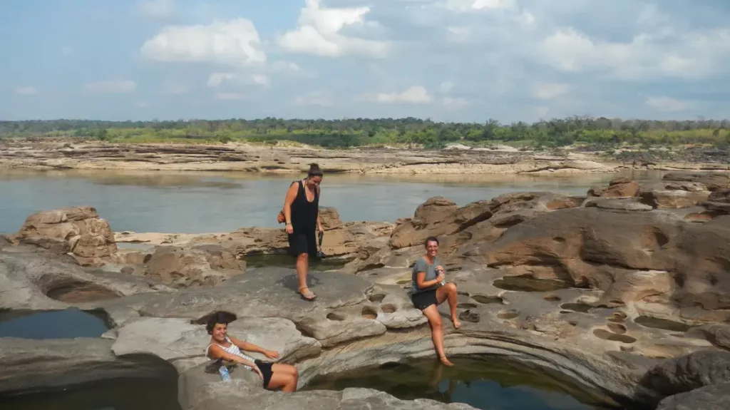 Hidden Thailand: Visitors exploring the distinctive rock formations and natural pools at Sam Phan Bok, Ubon Ratchathani