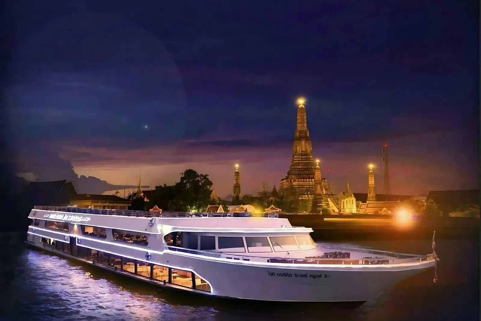 Dinner cruise on the Chao Phraya River at night with Wat Arun in Bangkok